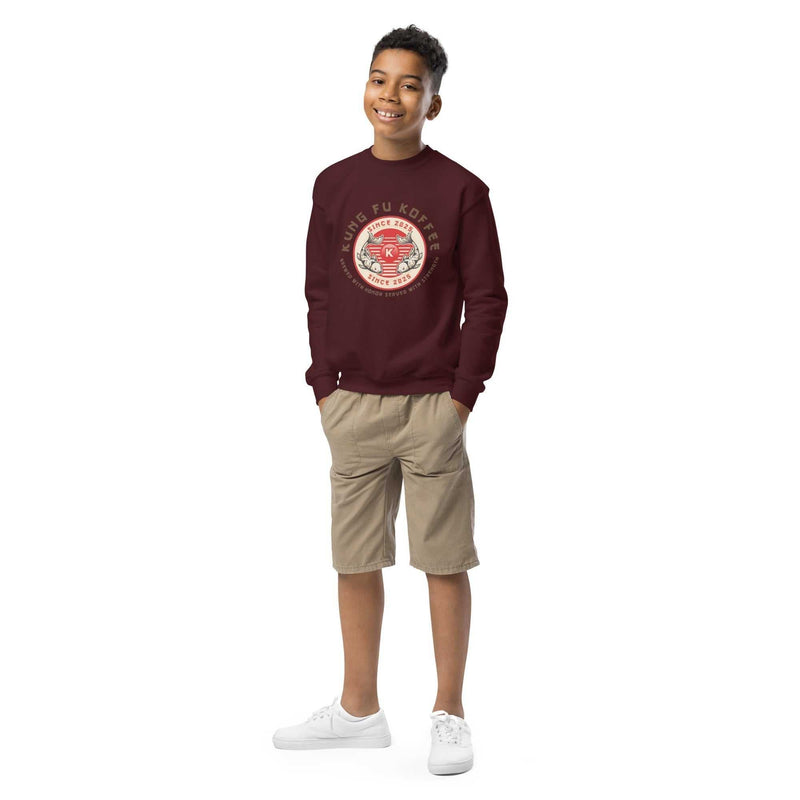 youth wearing maroon crewneck sweatshirt with Kung Fu Koffee logo and beige shorts